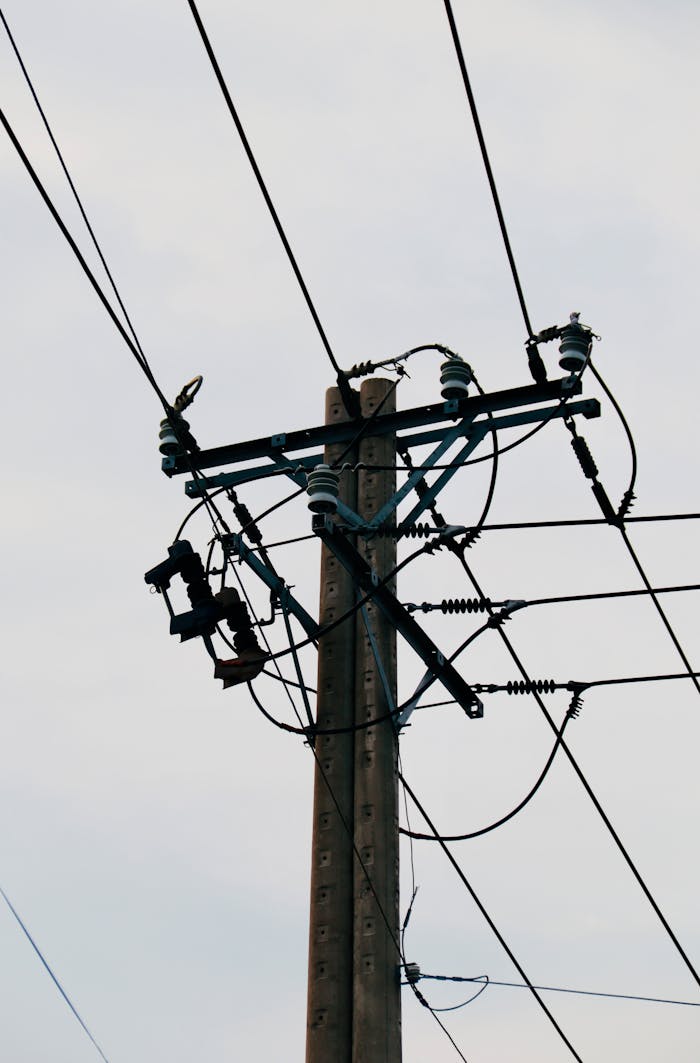 Close-up view of a utility pole with power lines, showcasing urban infrastructure.